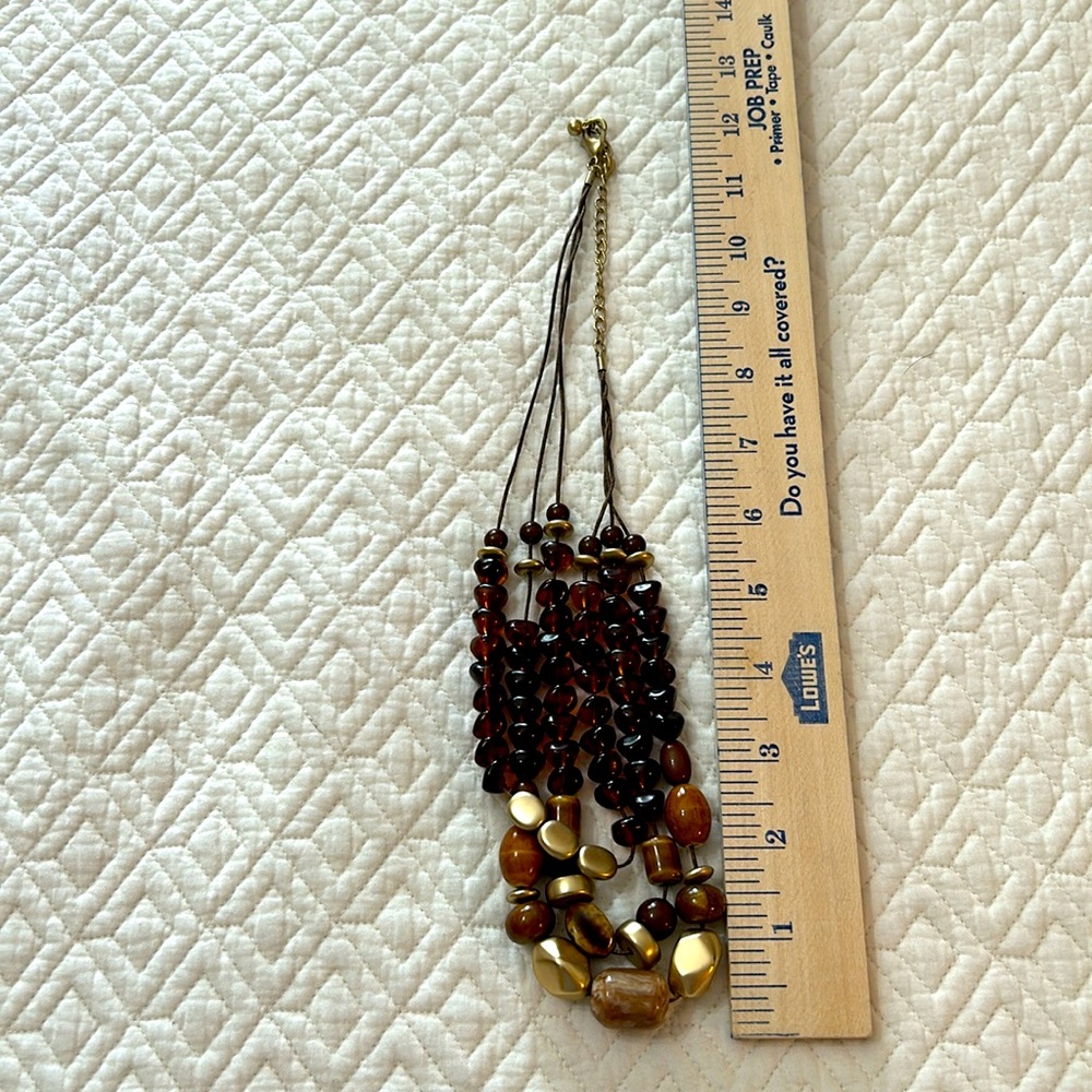 Chico’s three strand necklace with gold and various shades of brown beads. - Picture 4 of 4